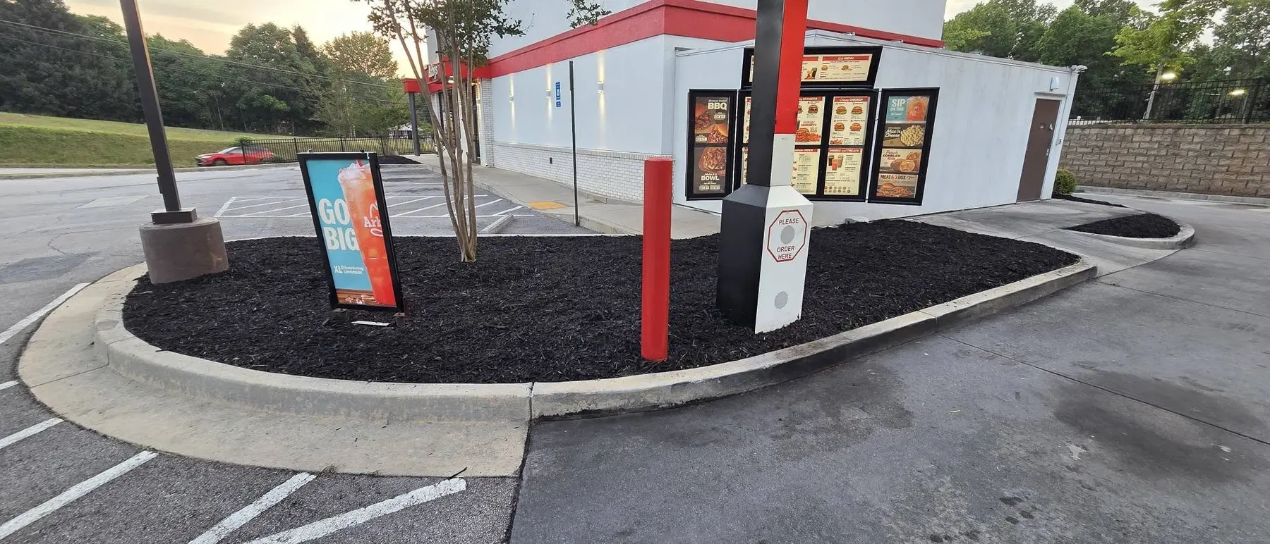 Refreshed landscape bed and clean curb line beside the Arby’s drive-through