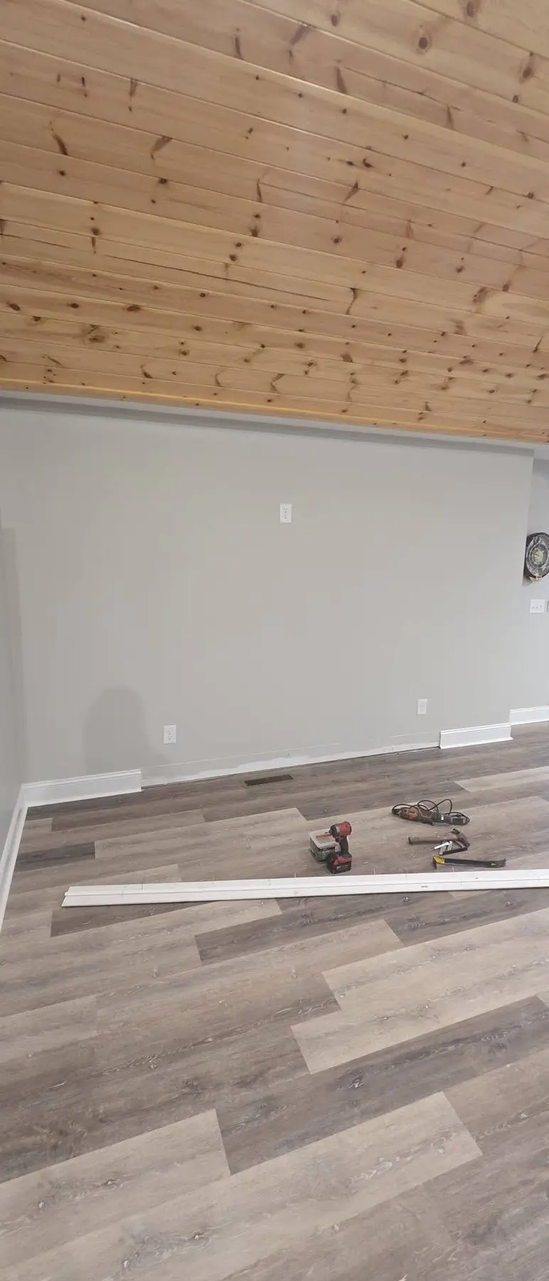 Blank living room wall before construction of the custom TV and fireplace feature