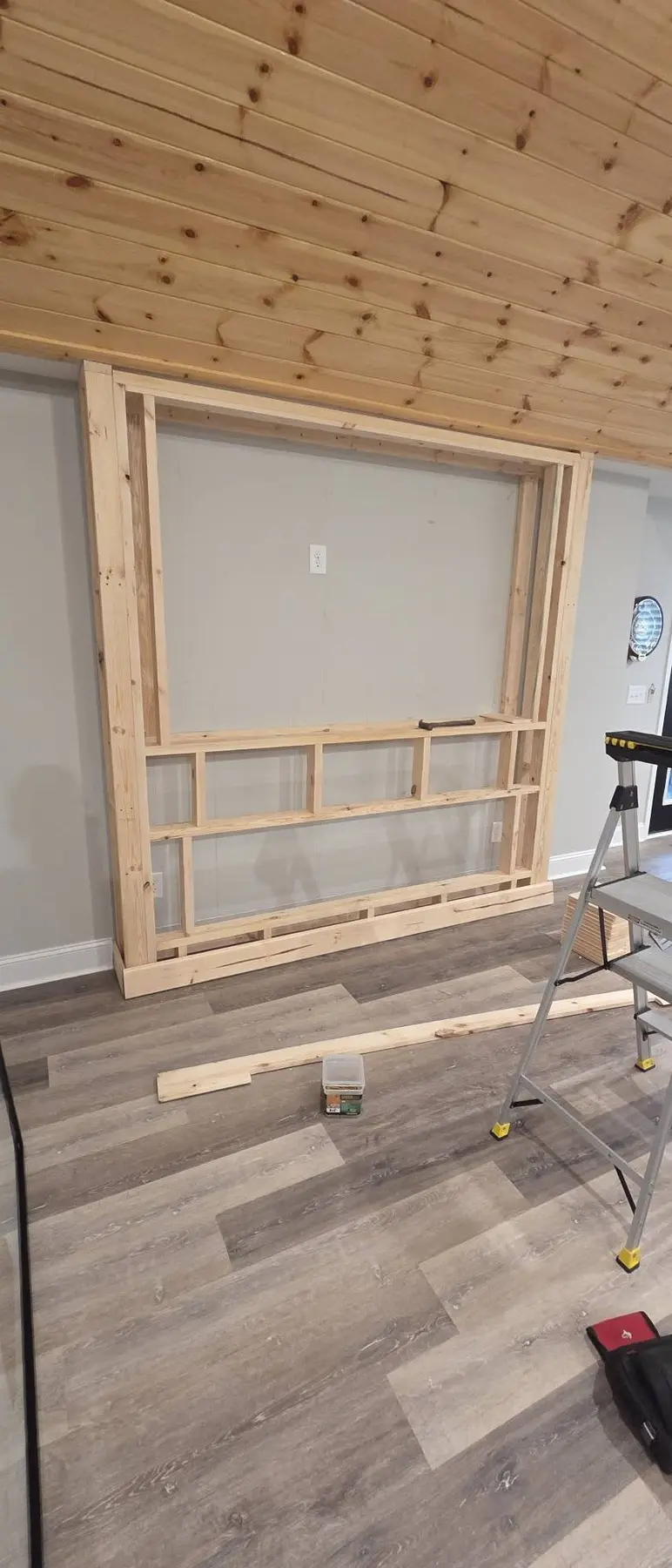Custom wood framing for the TV and electric fireplace feature wall